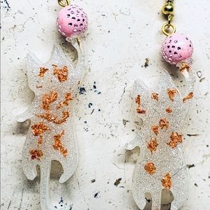 White Playful Cat Dangles with Pink Ball